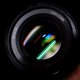a person holding a camera lens in their hand