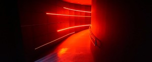 a long hallway with a red light coming from it